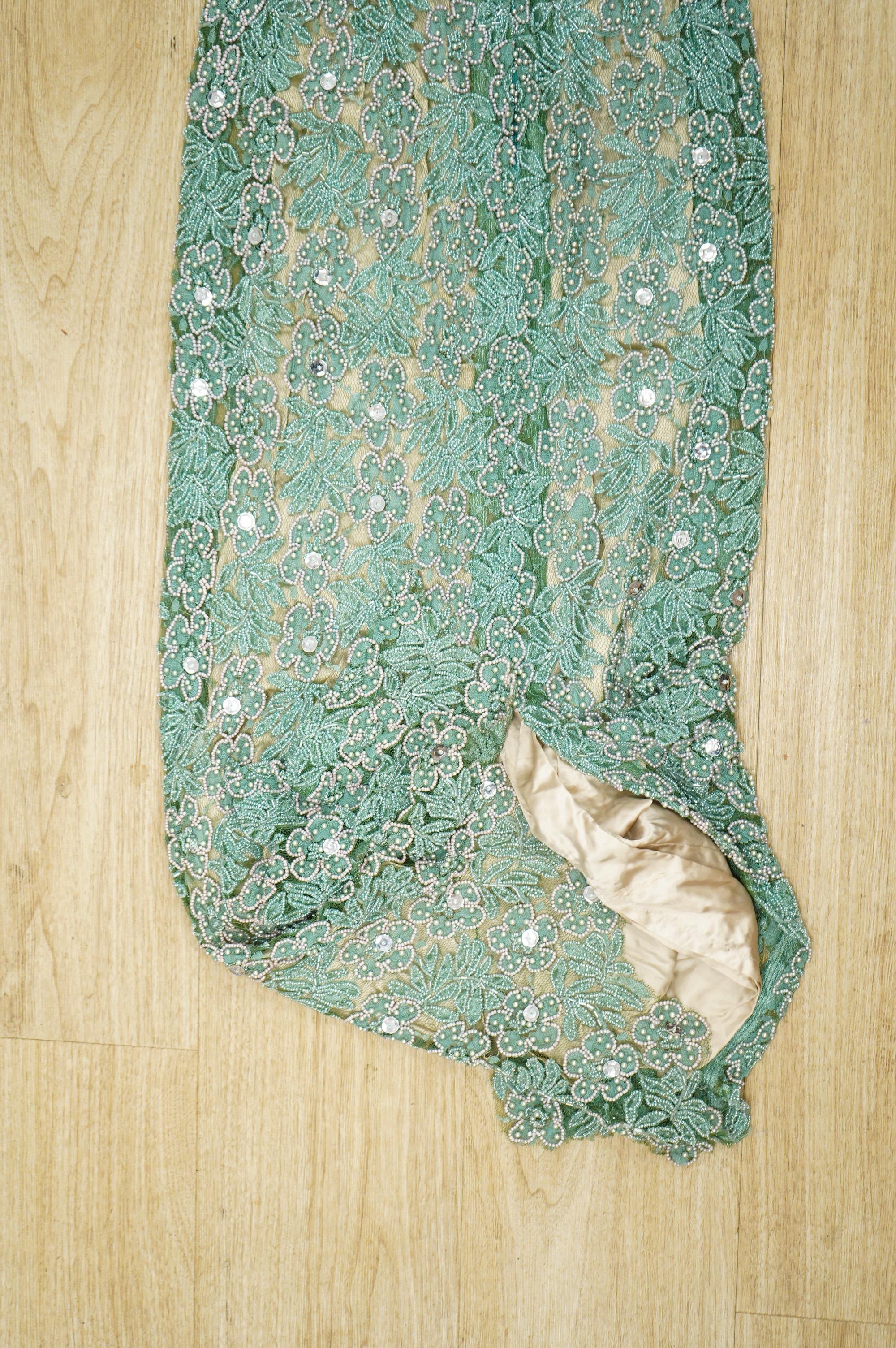 A 1960’s-70’s light green beaded and sequin floral net, fitted full length evening dress. 134cm long